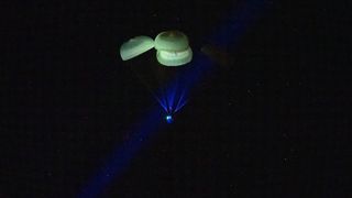 The SpaceX Crew-5 Dragon Endurance capsule descends to Earth under parachutes as it splashes down in the Gulf of Mexico off the coast of Tampa Bay, Florida on March 11, 2023, returning four astronauts to Earth after 5 months.