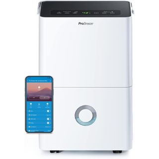 white dehumidifier with smart phone showing app