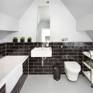 bathroom with white wall brown tiles