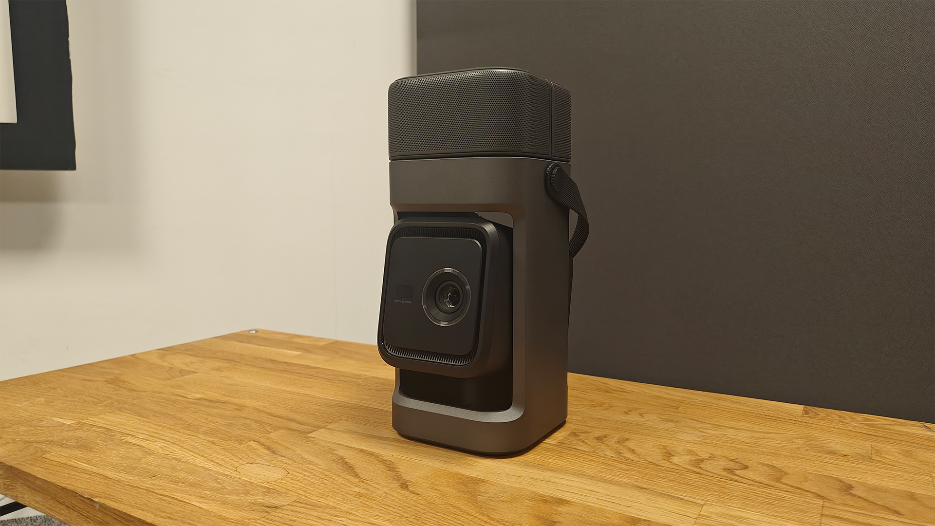 Soundcore Nebula P1 projector on wooden AV rack with speakers attached to main body