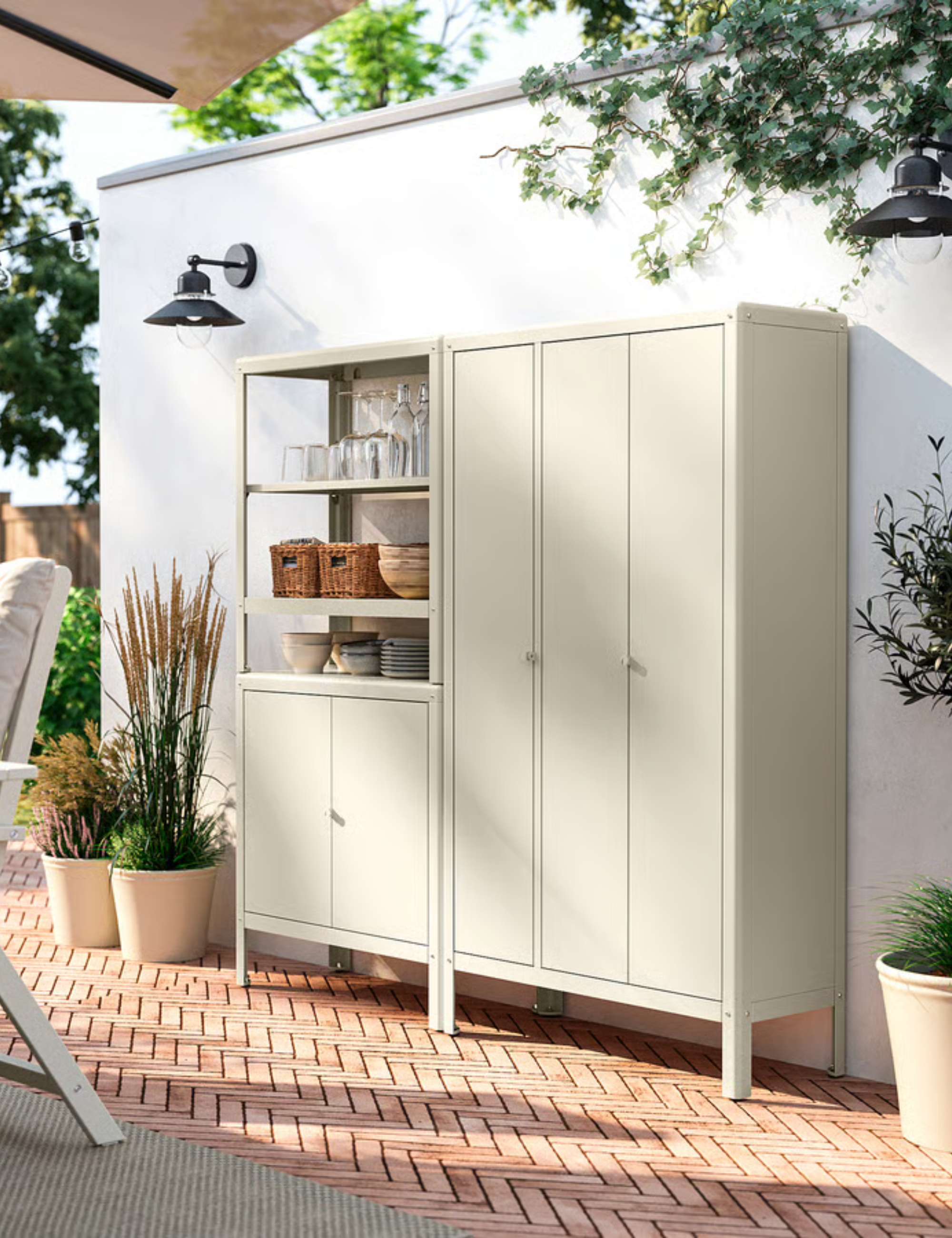 IKEA kOLBJ&amp;Ouml;RN outdoor storage cabinet and shelves styled in a charming patio area with herringbone brick floors and potted plants.