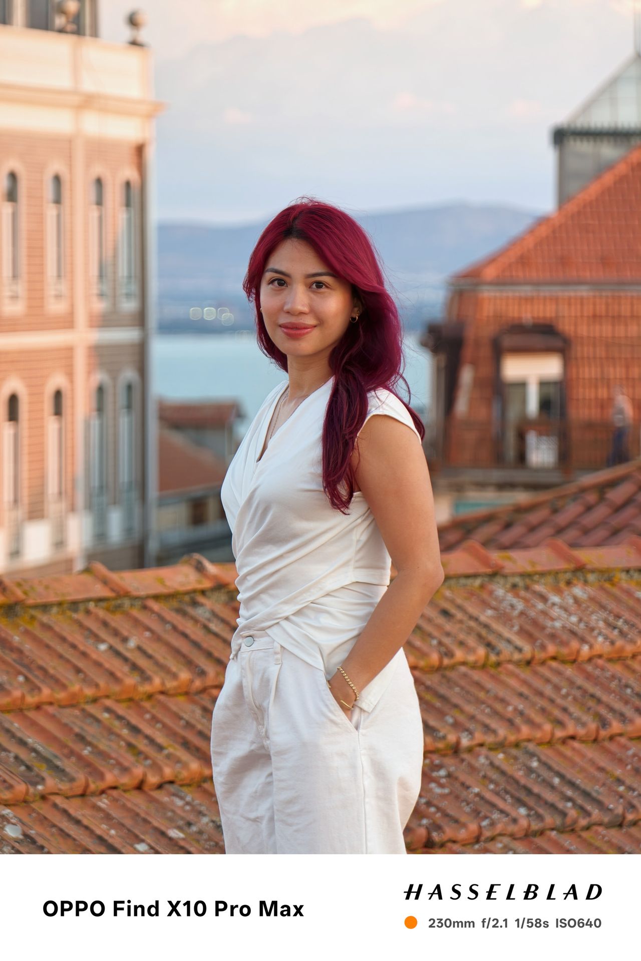 Oppo Find X10 Pro Max image sample gallery: portrait of a woman with pink hair in white jump suit, on a rooftop in Lisbon, Portugal