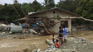 Tree trunks and debris washed away by flash floods are seen lodged in a damaged house in Sentani near the provincial capital of Jayapura, Indonesia's eastern Papua province, on March 17, 2019.
