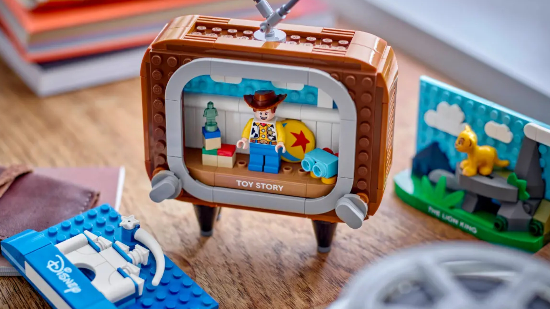 Toy Story, Disney, and The Lion King scenes in Lego on a tiny TV