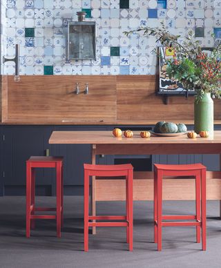 Kitchen table with stools painted in Harissa by Farrow and Ball