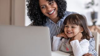 A mother and daughter happily browse the internet