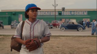 Max in her baseball uniform outside Rockford Too & Screw
