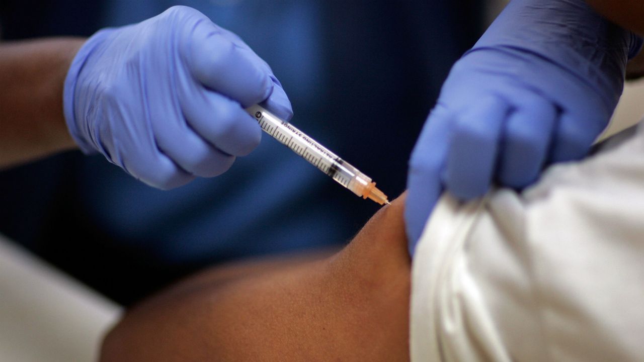 A doctor gives a subject an injection during Covid-19 vaccine trials.