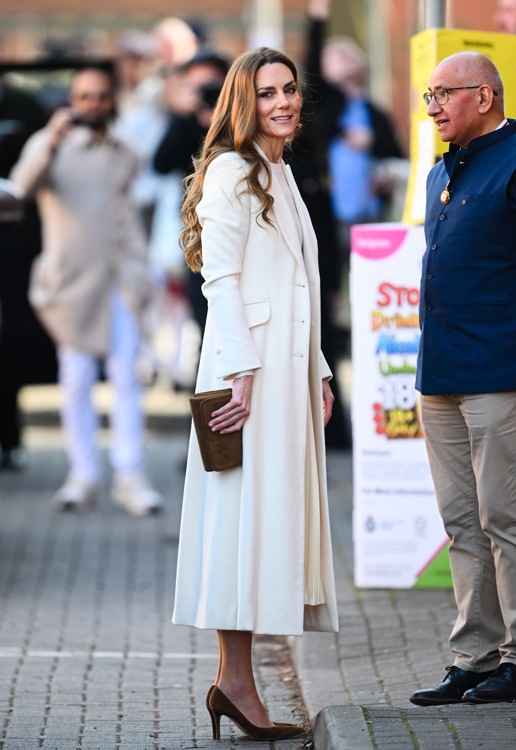 Princess Kate wearing a white coat and dress