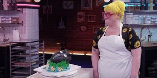 A contestant shows off her baking masterpiece on Netflix's Nailed It!