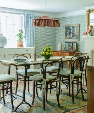 country style dining room with iron table, bistro chairs and ruffle lampshade