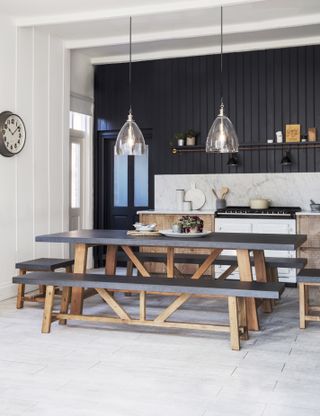 dining table with benches in dark wood with black table top by graham & green