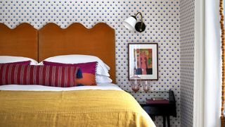 Orange-velvet upholstered headboard with scalloped edge