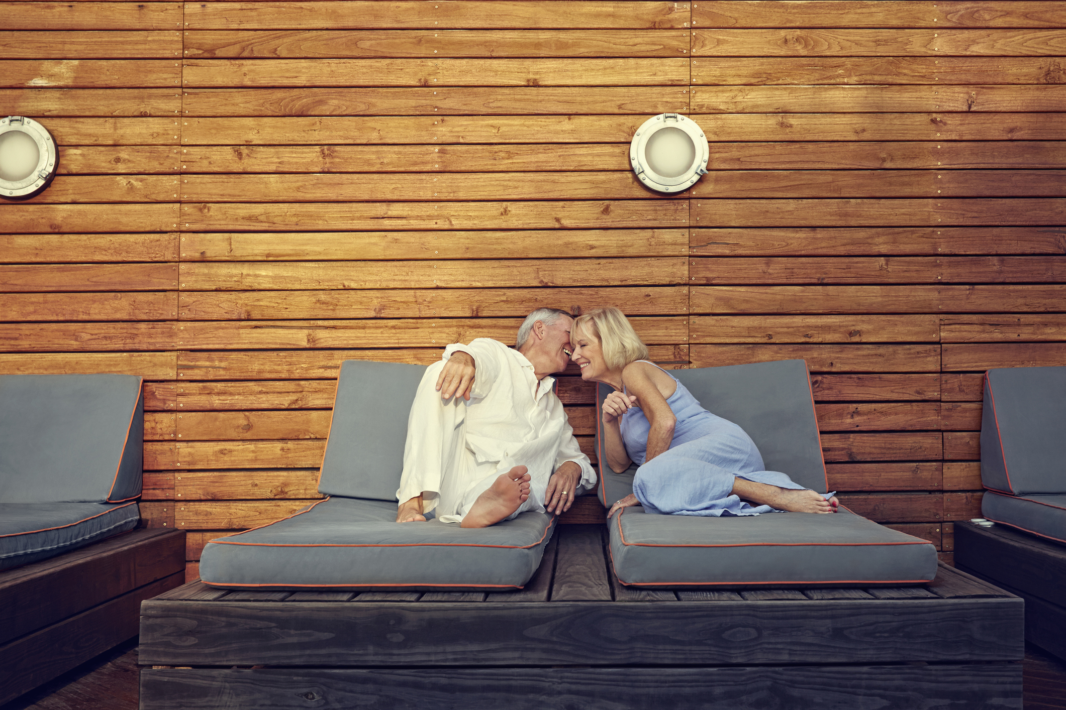Older Caucasian couple relaxing on lawn chairs
