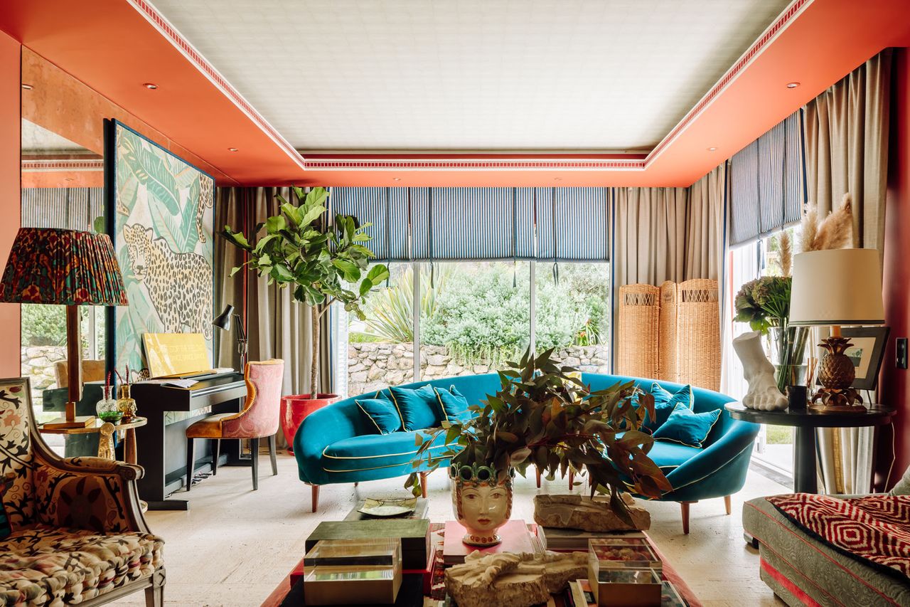 Orange ceiling, large mirror, blue crescent sofa
