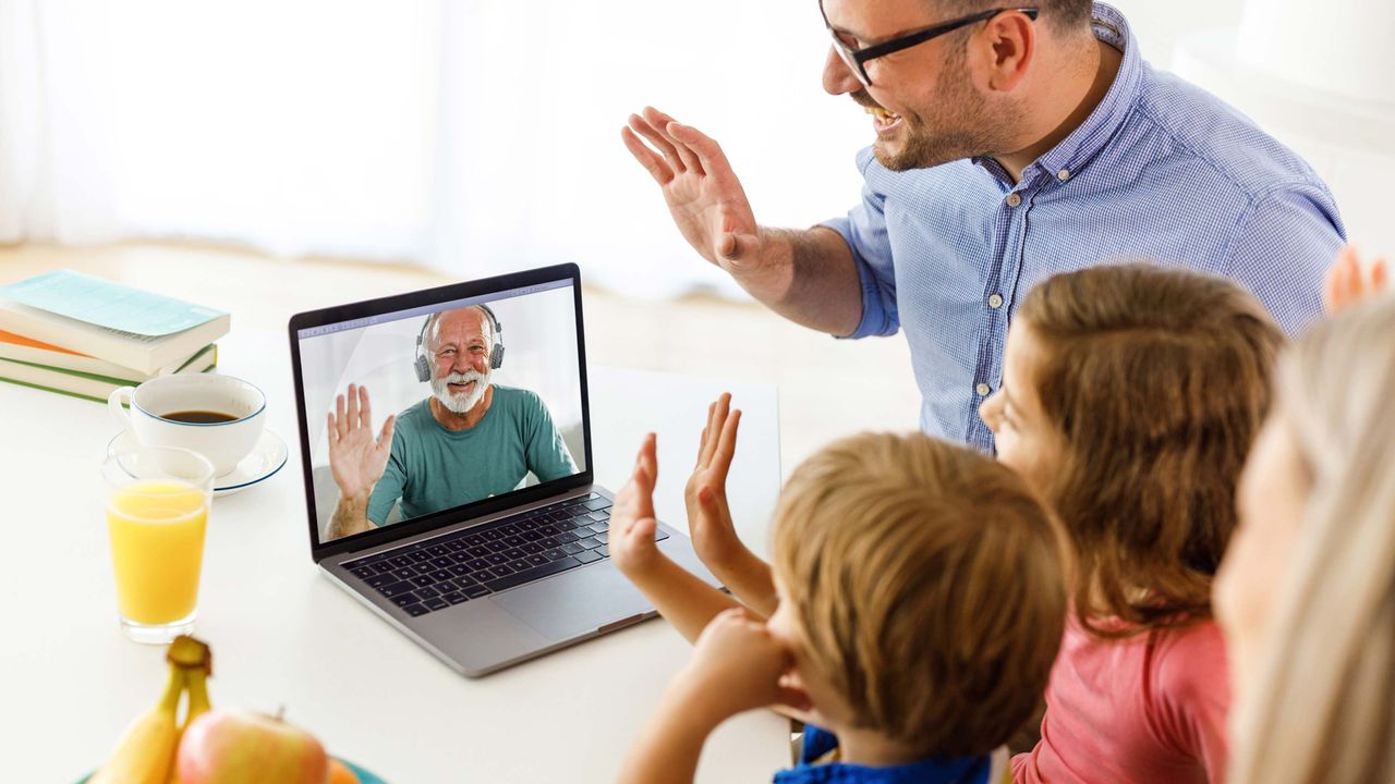 Happy senior man having a video call with his family through a computer.