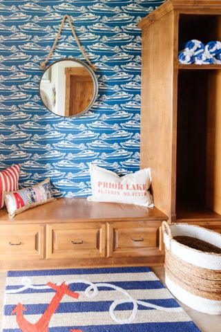 nautical themed mudroom with boat wallpaper and stripe rug