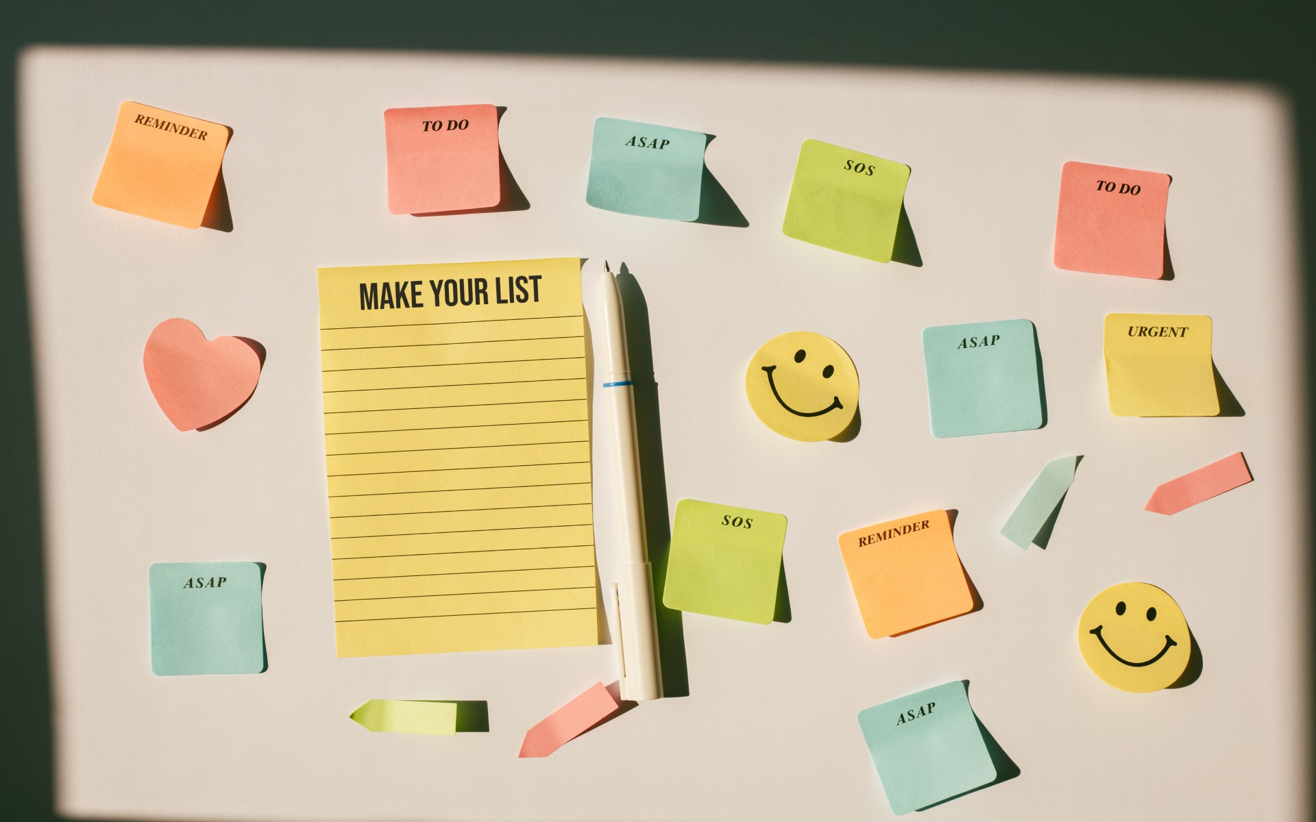 Make your list - text on a yellow piece of paper with sticky notes around