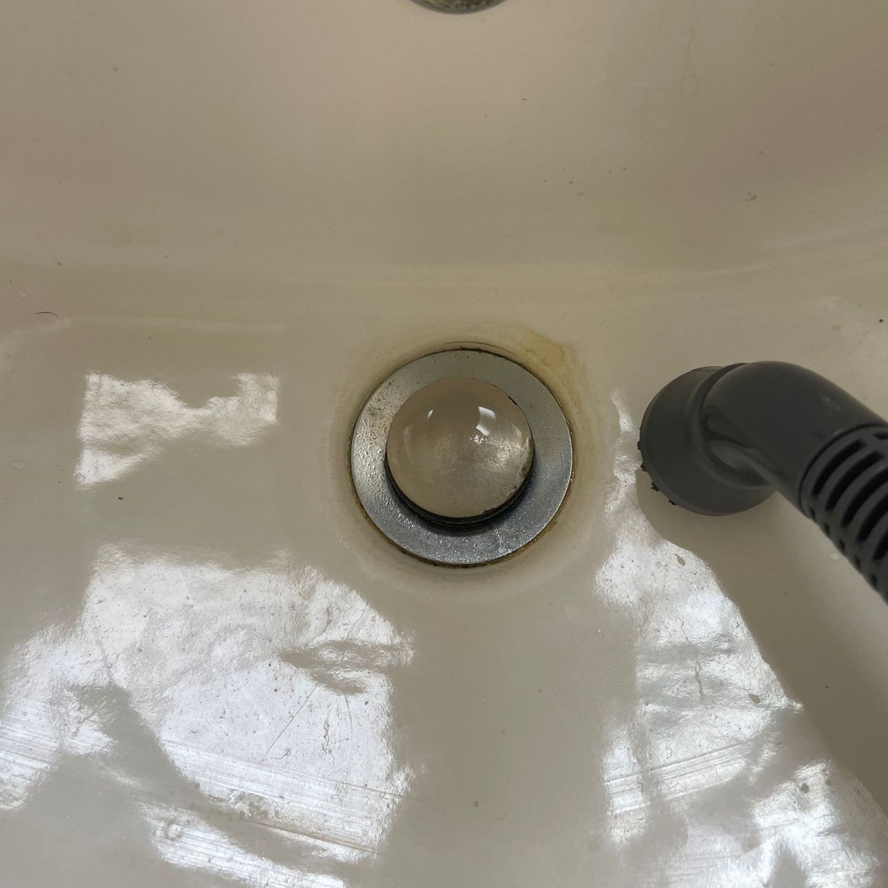 Using the Minky Opti-Clean Steam Cleaner to clean limescale on a sink plughole
