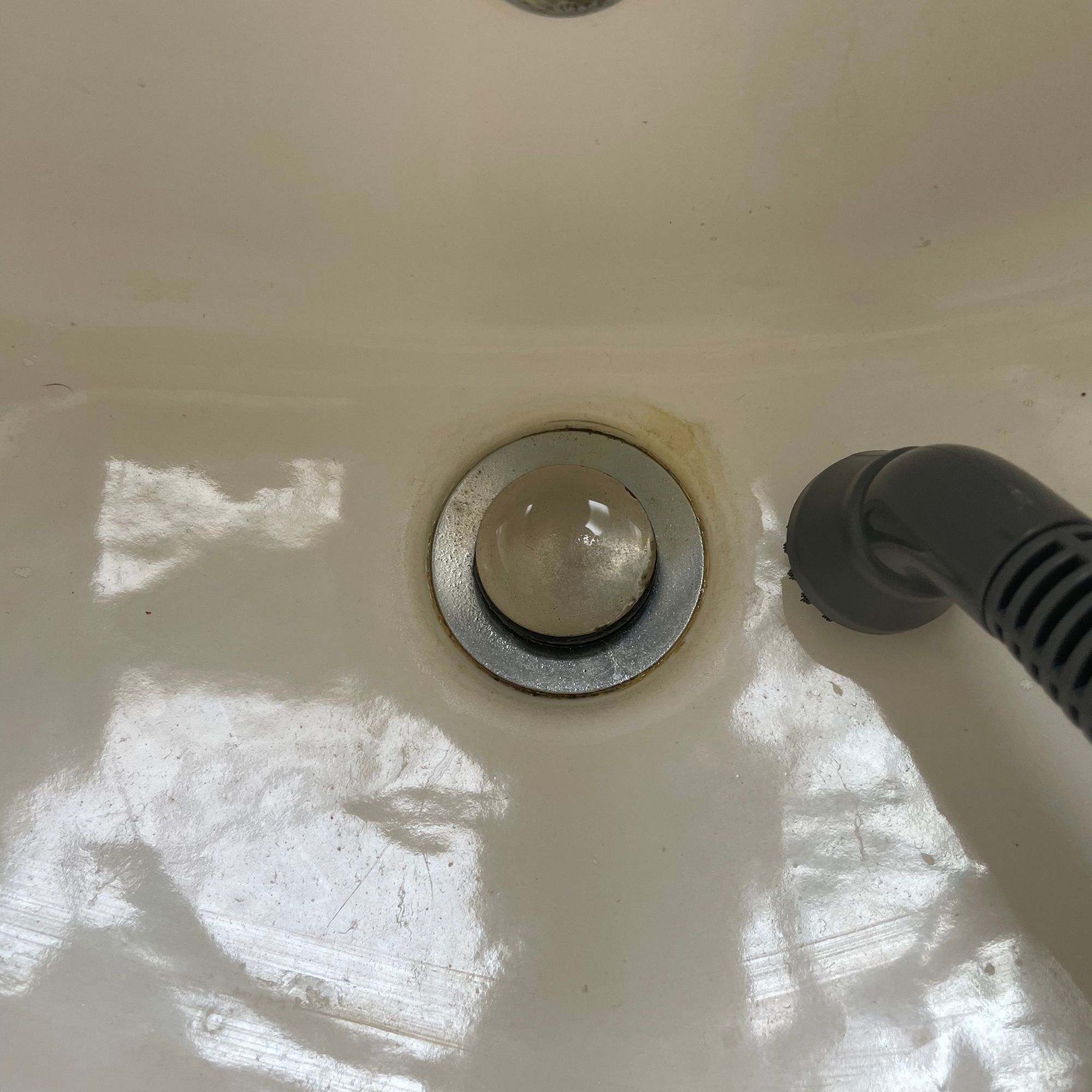 Using the Minky Opti-Clean Steam Cleaner to clean limescale on a sink plughole