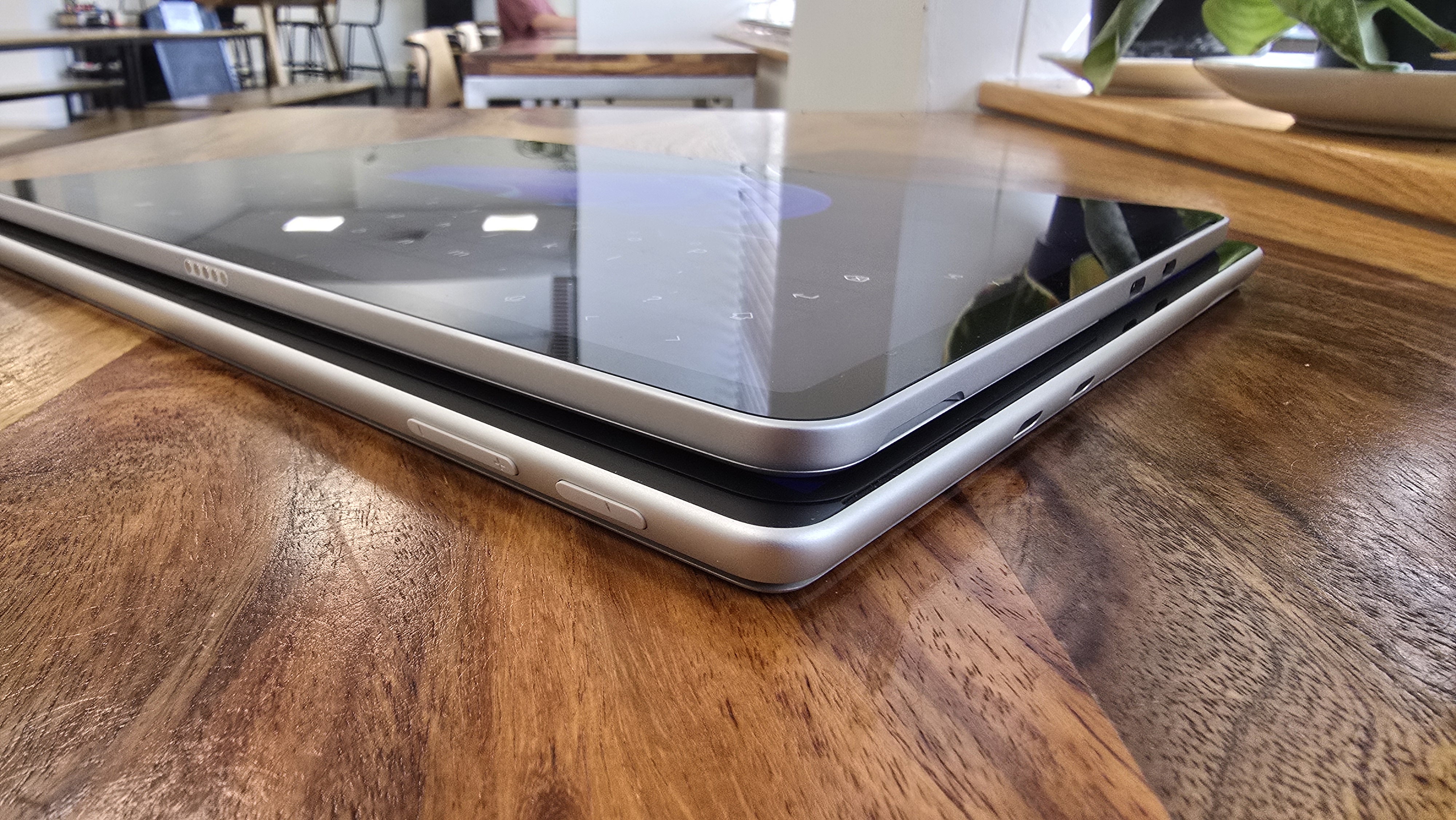 Microsoft Surface Pro 12 tablet on wooden table in relaxed cafe