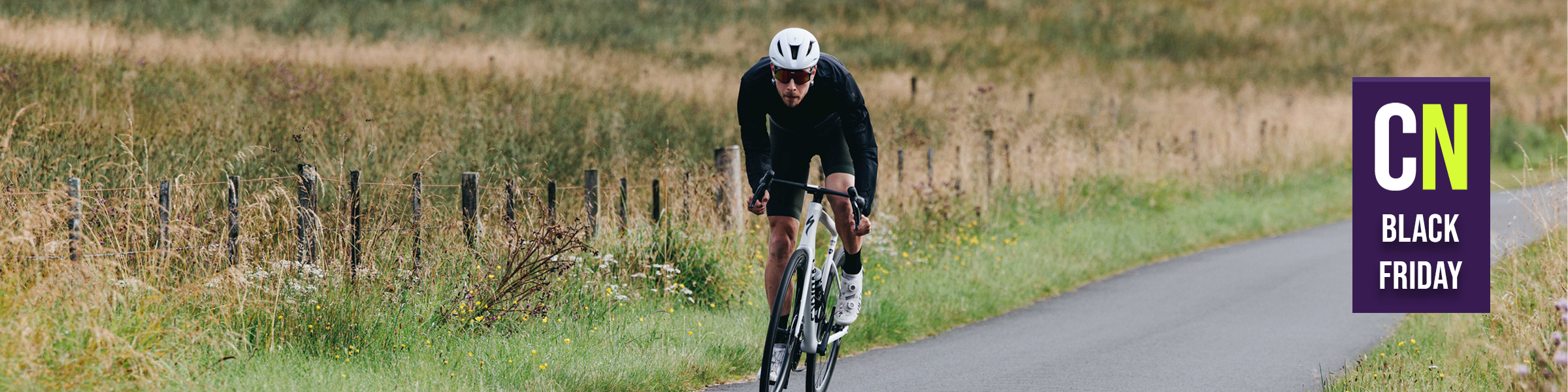 A photo of josh sprinting on a Specialized bike, overlaid with a Black Friday Bike Deals badge