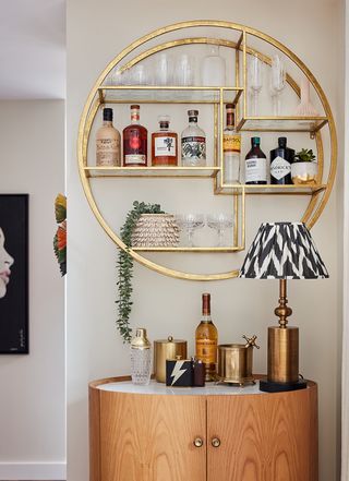 A living room corner with a gold-toned bar cabinet