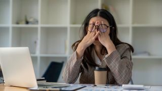 Woman looking tired at work
