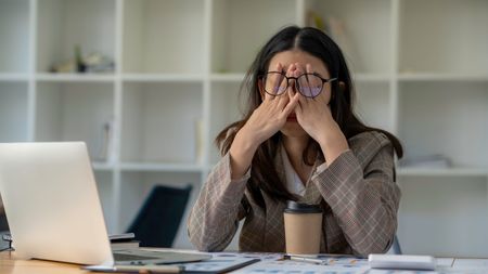 Woman looking tired at work