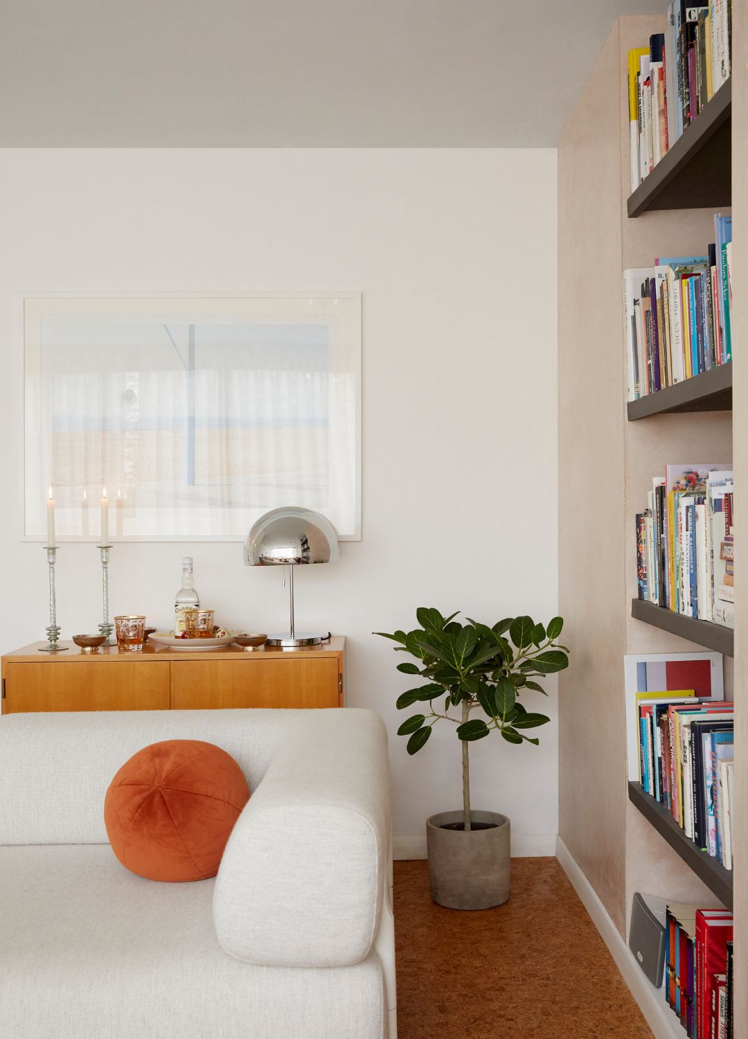 picture one a modernist with bookcase and low slung sofa