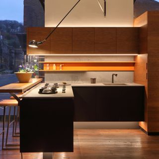 modern kitchen with raised breakfast bar and mood lighting including under-unit lighting