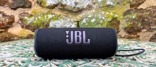 JBL Flip 6 speaker outside on garden table