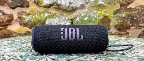 JBL Flip 6 speaker outside on garden table 
