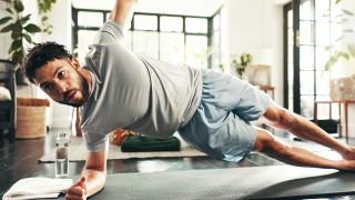 a man holding a side plank