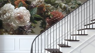 bold floral wallpaper in stairway with Georgian staircase