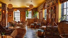 Restaurant at the Freehand Hotel with cane chairs and wall panelling