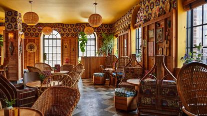 Restaurant at the Freehand Hotel with cane chairs and wall panelling