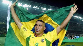 Ronaldo of Brazil celebrates with a Brazilian flag after victory in the 2002 FIFA World Cup final