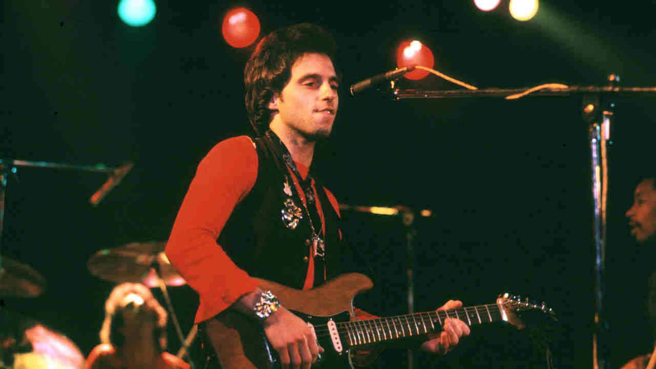 Nils Lofgren performing onstage in the 1970s