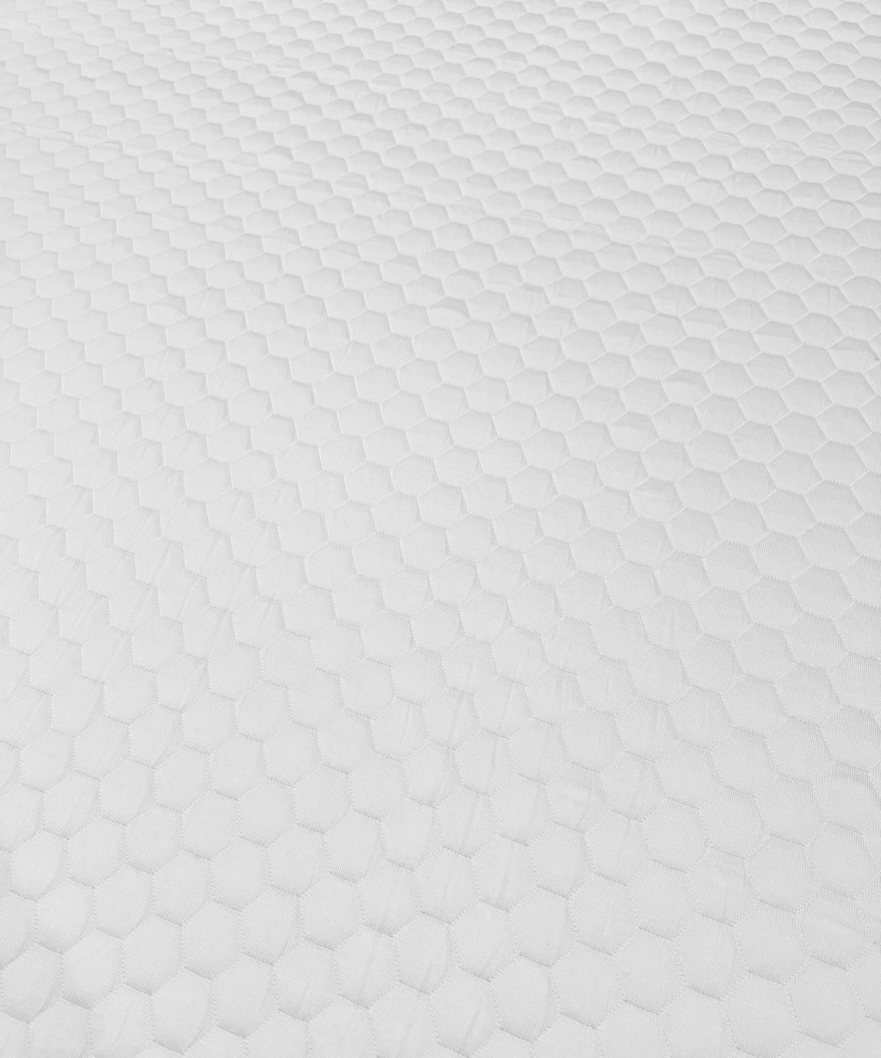 A close-up of a white Nolah AirFoam&reg; Luxe Mattress Topper