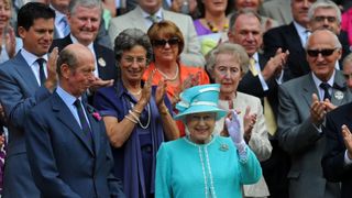 Queen Elizabeth II waves as she attends the match between Britain's Andy Murray and Finland's Jarkko Nieminen during her visit to the Wimbledon Tennis Championships
