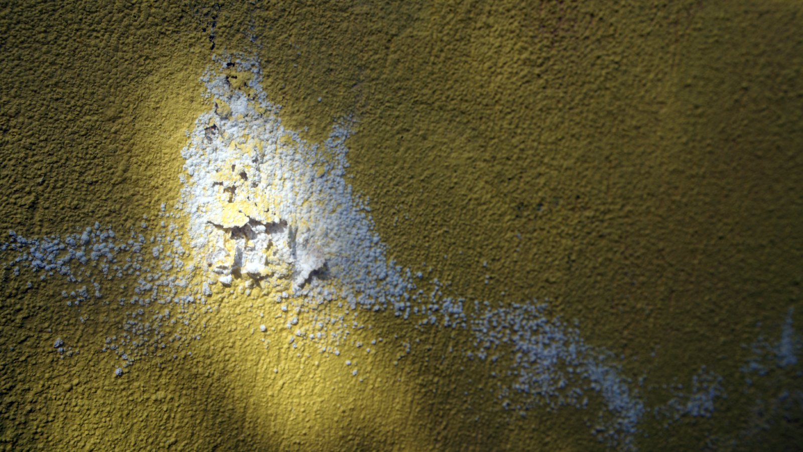 yellow wall with peeling plaster