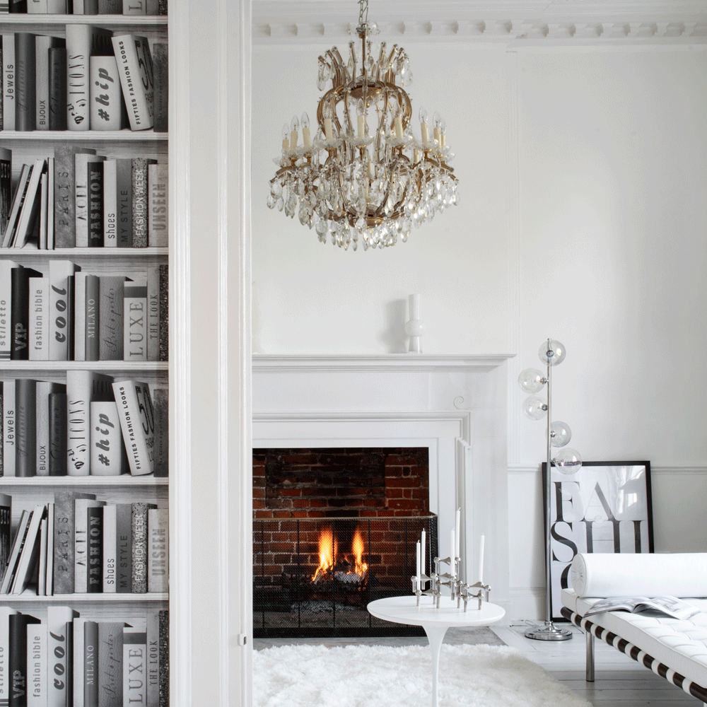 living room with books white frame and white sofa
