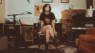 A photo of Lilly Hiatt sitting on a chair in her home studio in Nashville, where she recorded her 2025 album 'Forever.'