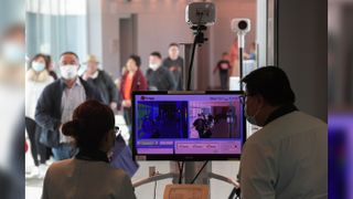 Health officers screen arriving passengers from China with thermal scanners at Changi International airport in Singapore on Jan. 22, 2020, as authorities increased measures against the spread of the newfound coronavirus.