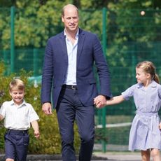 Prince William and Kate Middleton hold hands with their three kids