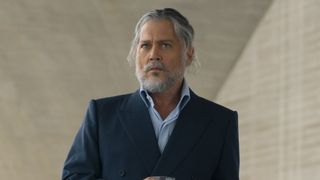 Johnny Depp's mysterious character wearing light blue shirt under a blue blazer, with long gray hair tied back, and a gray beard and mustache in Day Drinker