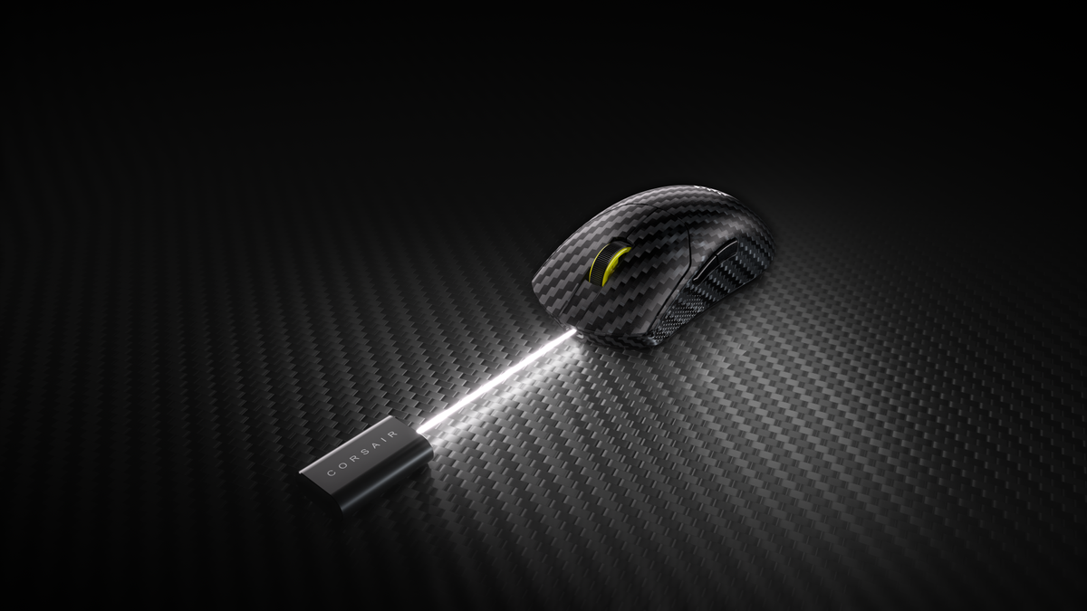 A Corsair Sabre V2 Pro CF gaming mouse on a textured floor, with a wireless dongle on top.
