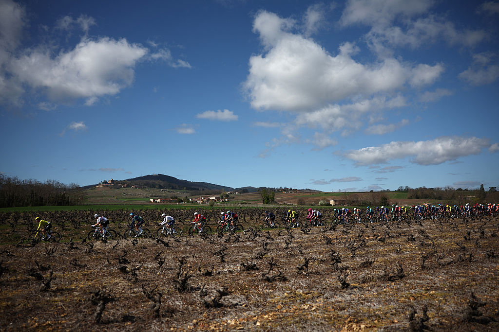 The pack rides during the 5th stage of the Paris-Nice cycling race, 206.3 km between Cormoranche-sur-Sa&ocirc;ne and Colombier-le-Vieux, on March 12, 2026. (Photo by Anne-Christine POUJOULAT / AFP)