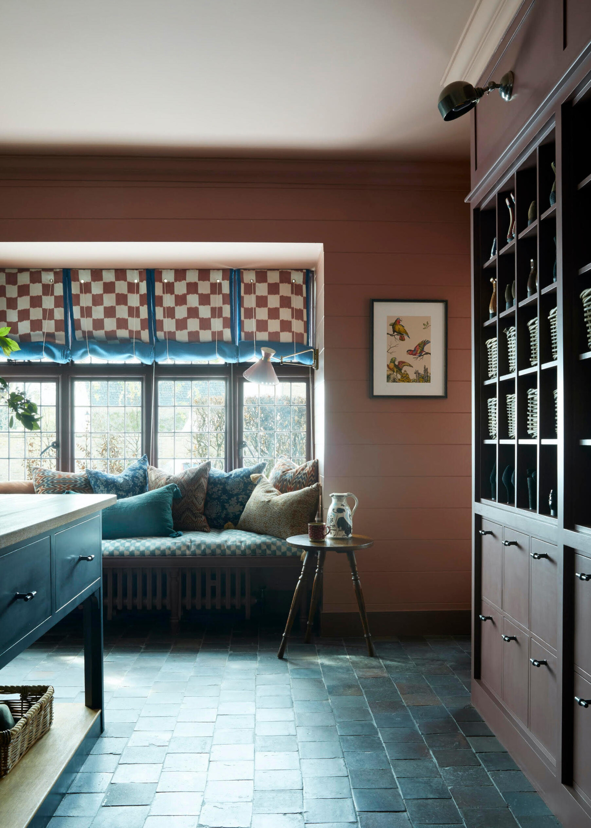 banquette window seat in a kitchen with stone tiled floor